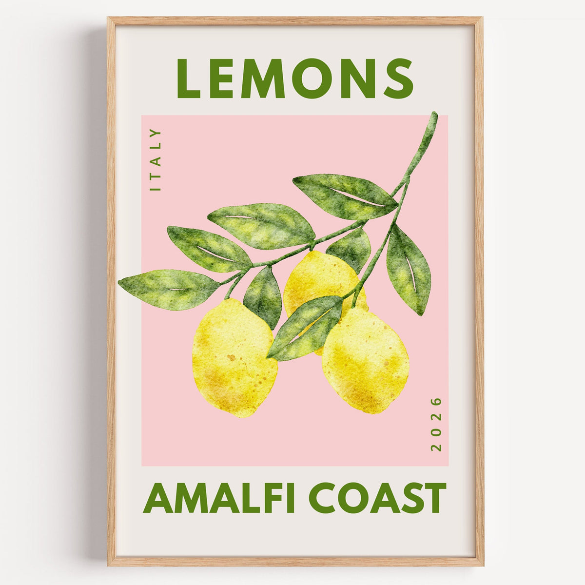 Lemons Amalfi Coast branch print in a light oak frame on a plain white wall