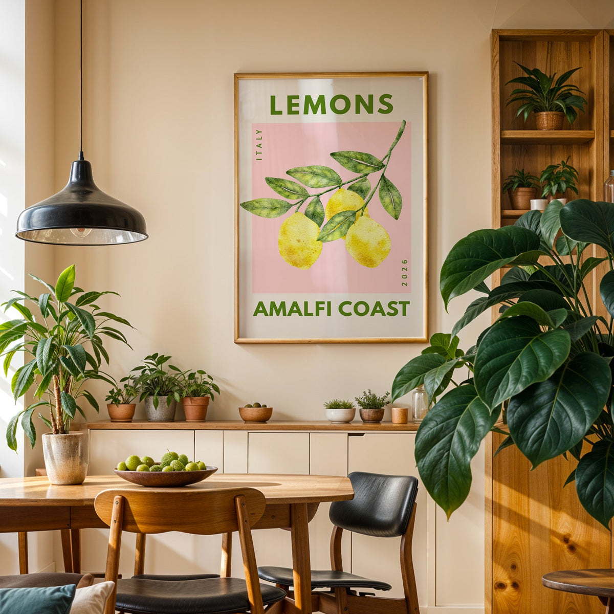 Lemons Amalfi Coast print in an oak frame in a dining room above a plant-lined sideboard