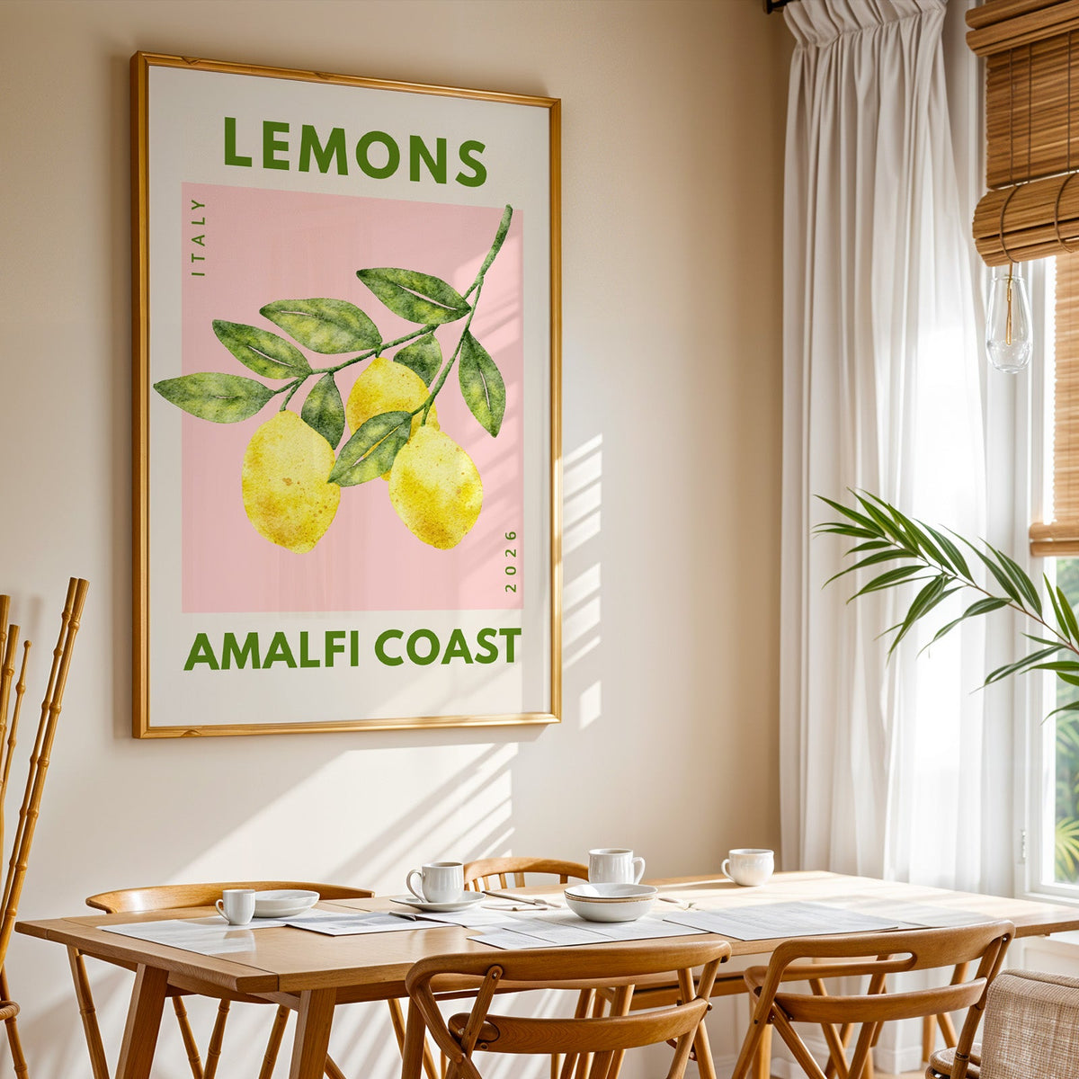 Lemons Amalfi Coast print shown in a gold frame above a breakfast table by a curtained window