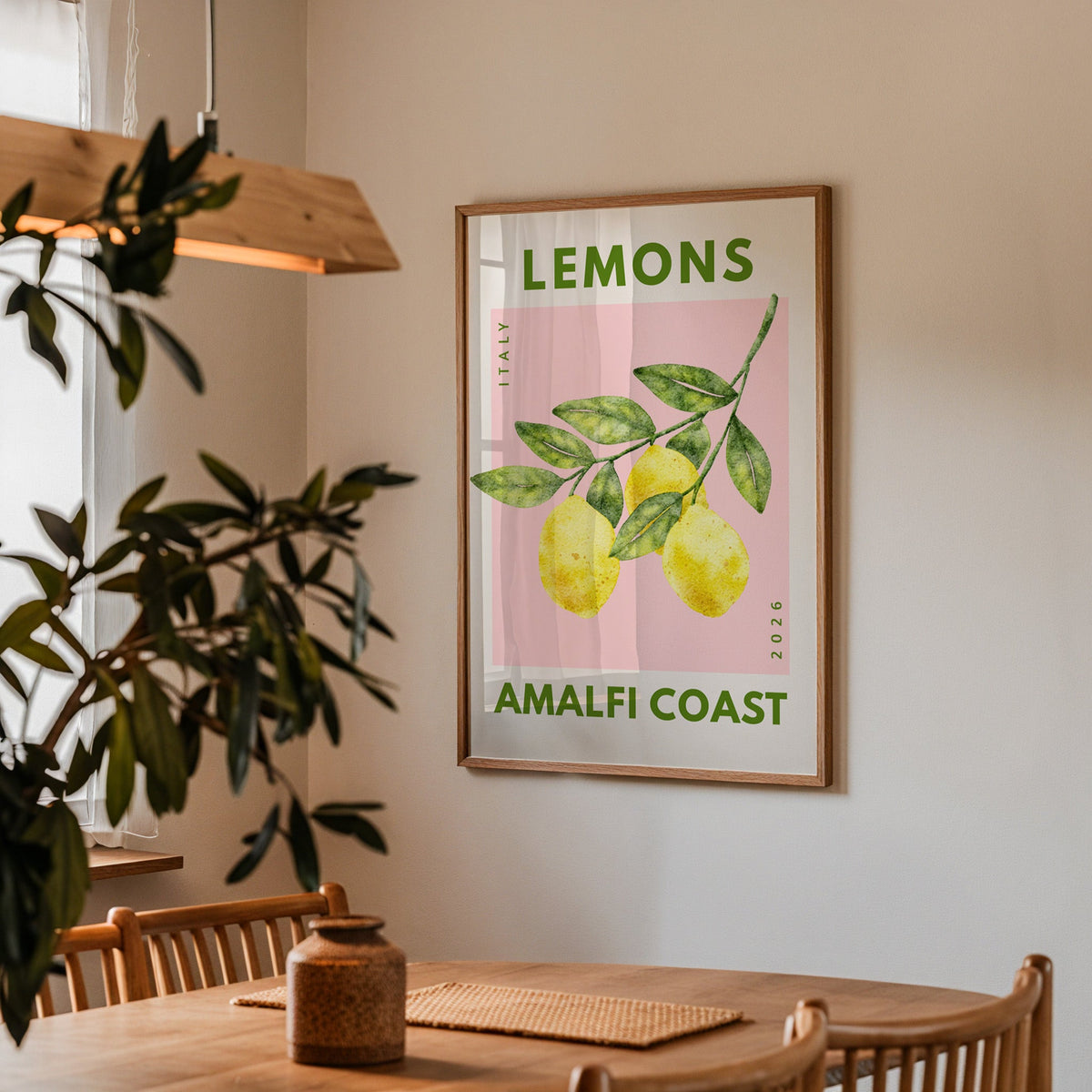 Lemons Amalfi Coast print in a walnut frame above a dining table with olive branches