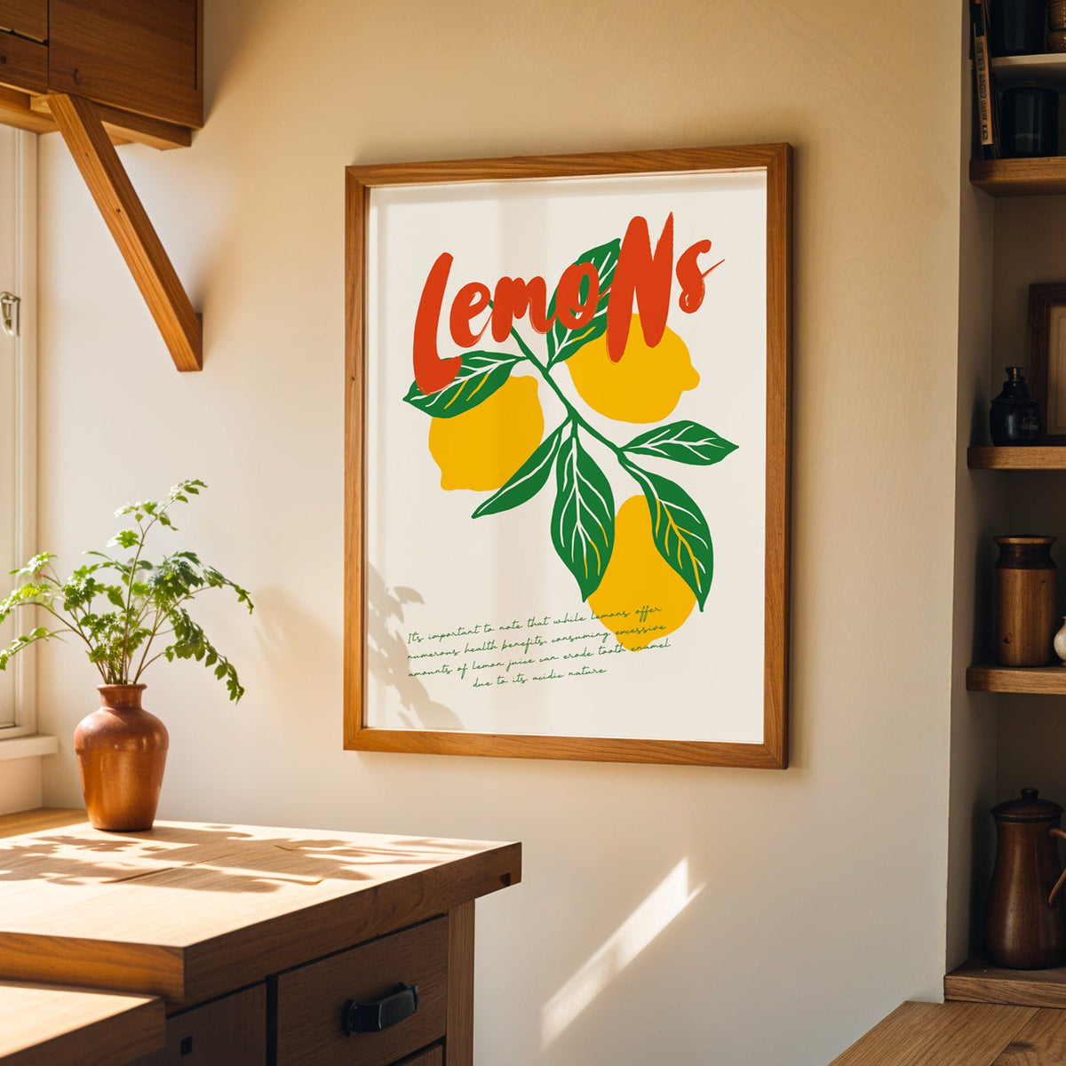 Yellow lemons print in a wood frame on a sunlit kitchen wall beside open shelving