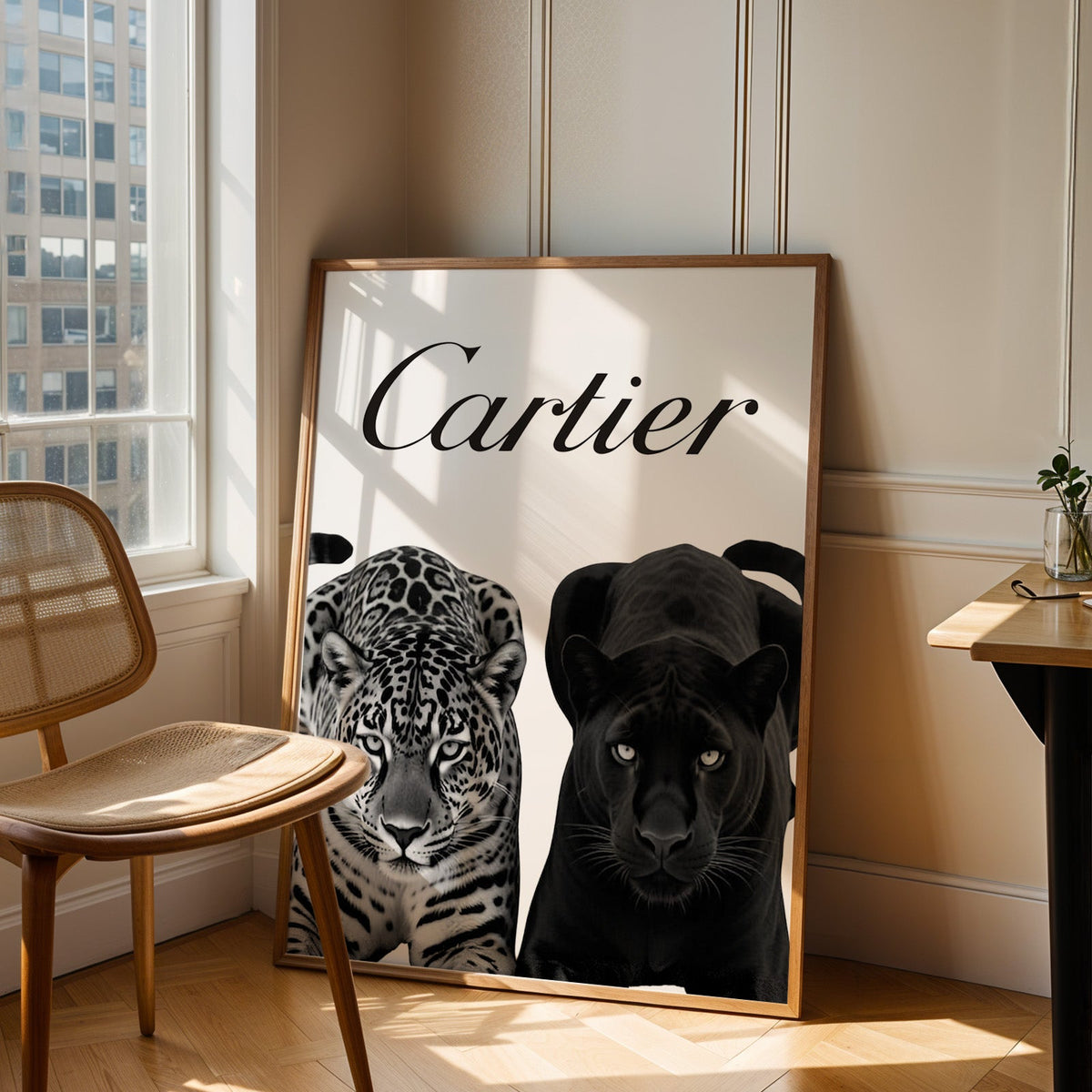 Spotted leopard and black panther pair print in an oak frame leaning in a sunlit corner beside a cane chair