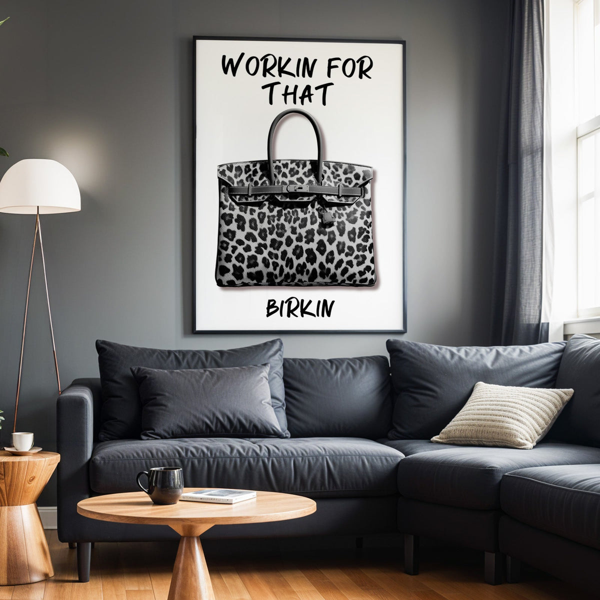 Leopard fur structured handbag with brush lettering print in a black frame above a charcoal sofa on a grey wall