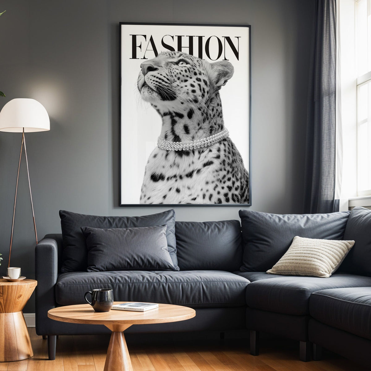 Leopard wearing pearl necklace fashion cover print in a black frame above a charcoal sofa on a grey wall