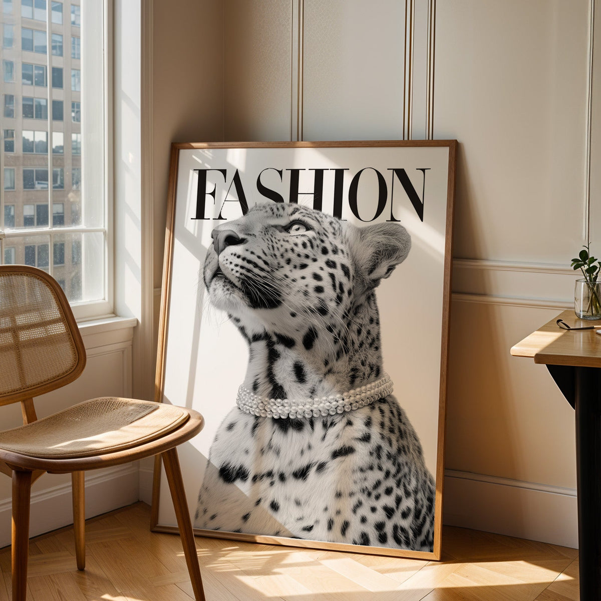 Leopard wearing pearl necklace fashion cover print in an oak frame leaning in a sunlit corner beside a cane chair