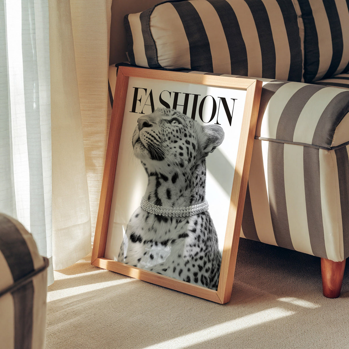 Leopard wearing pearl necklace fashion cover print in a pine frame leaning against a striped armchair