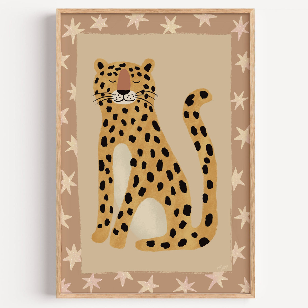 Smiling leopard with star border nursery print in a light oak frame on a plain white wall