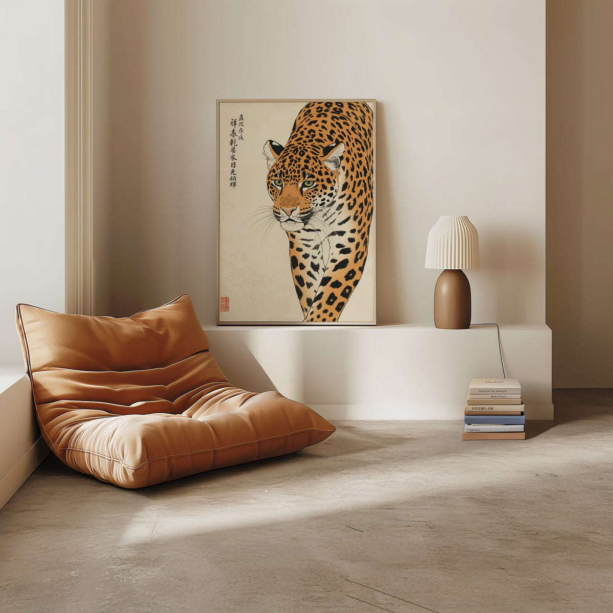 prowling leopard with calligraphy print in a light oak frame on a white ledge by a tan leather floor chair