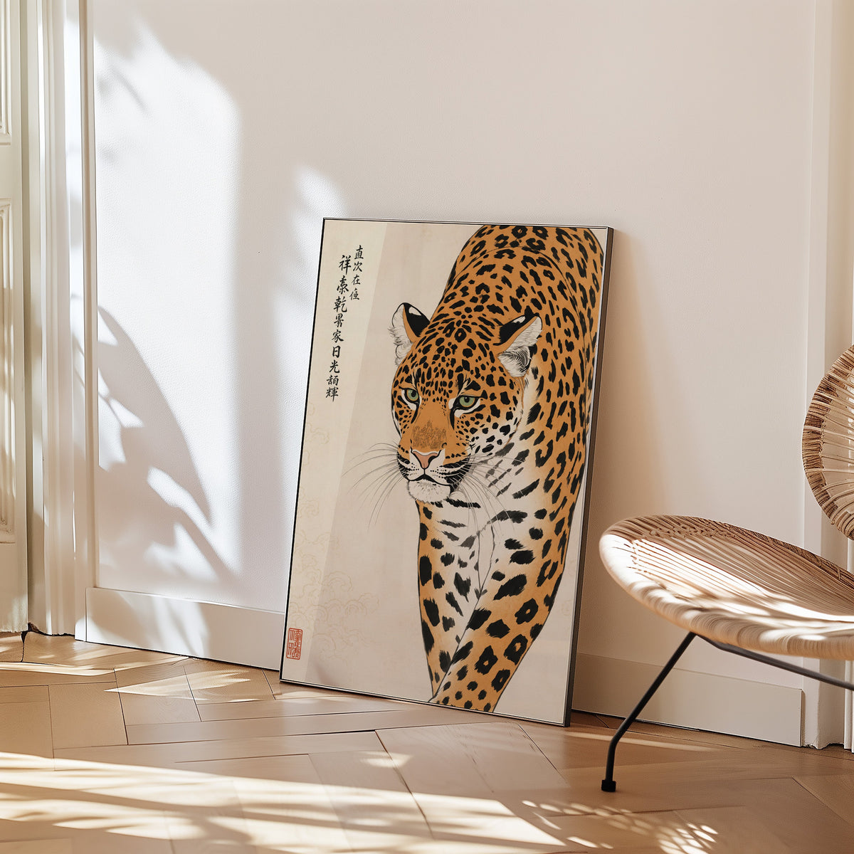 prowling leopard with calligraphy print in a black frame leaning on a herringbone floor beside a woven rattan chair