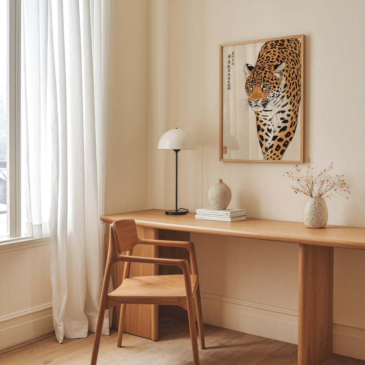 prowling leopard with calligraphy print in an oak frame above a long oak desk with a white dome lamp and woven vases