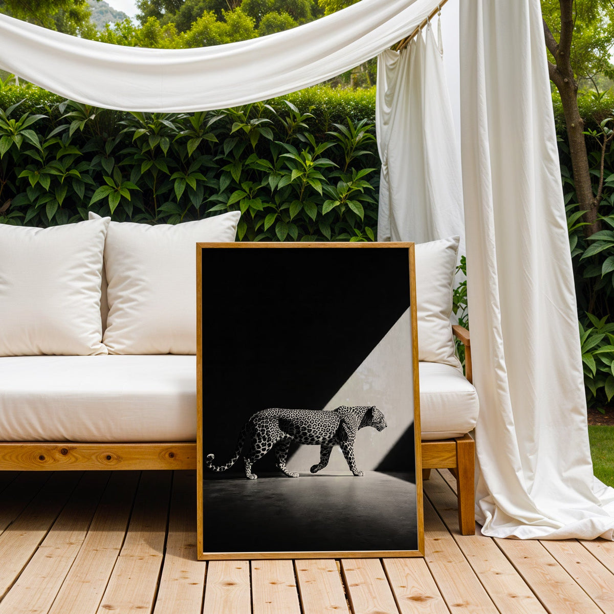 Leopard walking across dark floor in light beam print in an oak frame on an outdoor daybed under white drapes