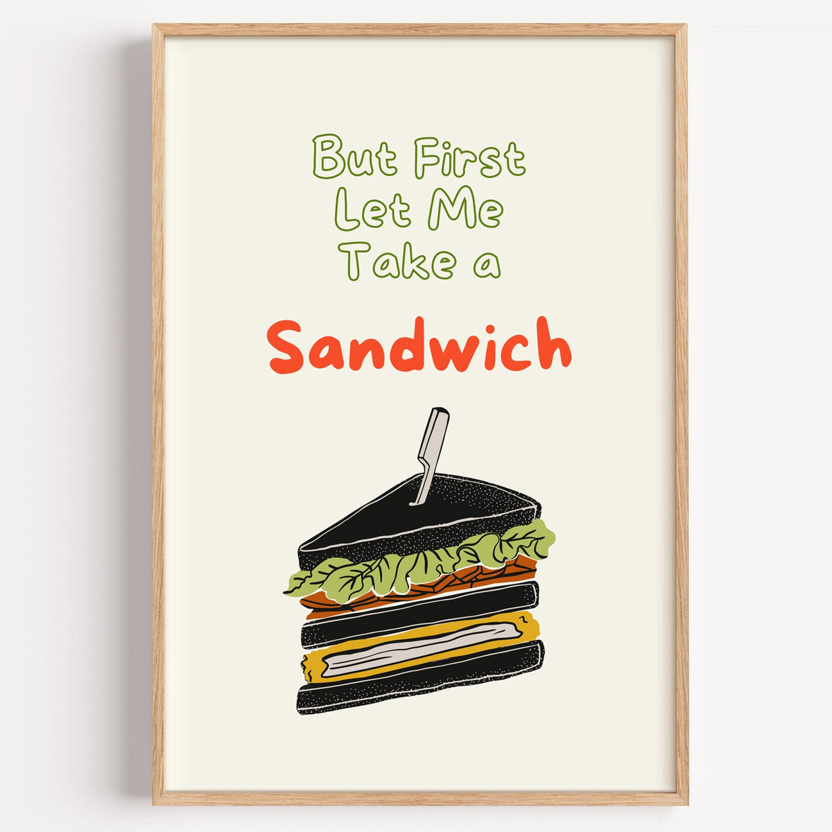 Let Me Take a Sandwich club sandwich print in a light oak frame on a plain white wall