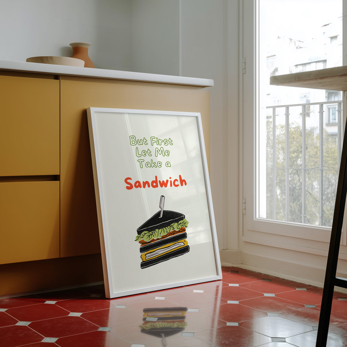 Club sandwich print in a white frame against yellow cabinets on a red tiled floor