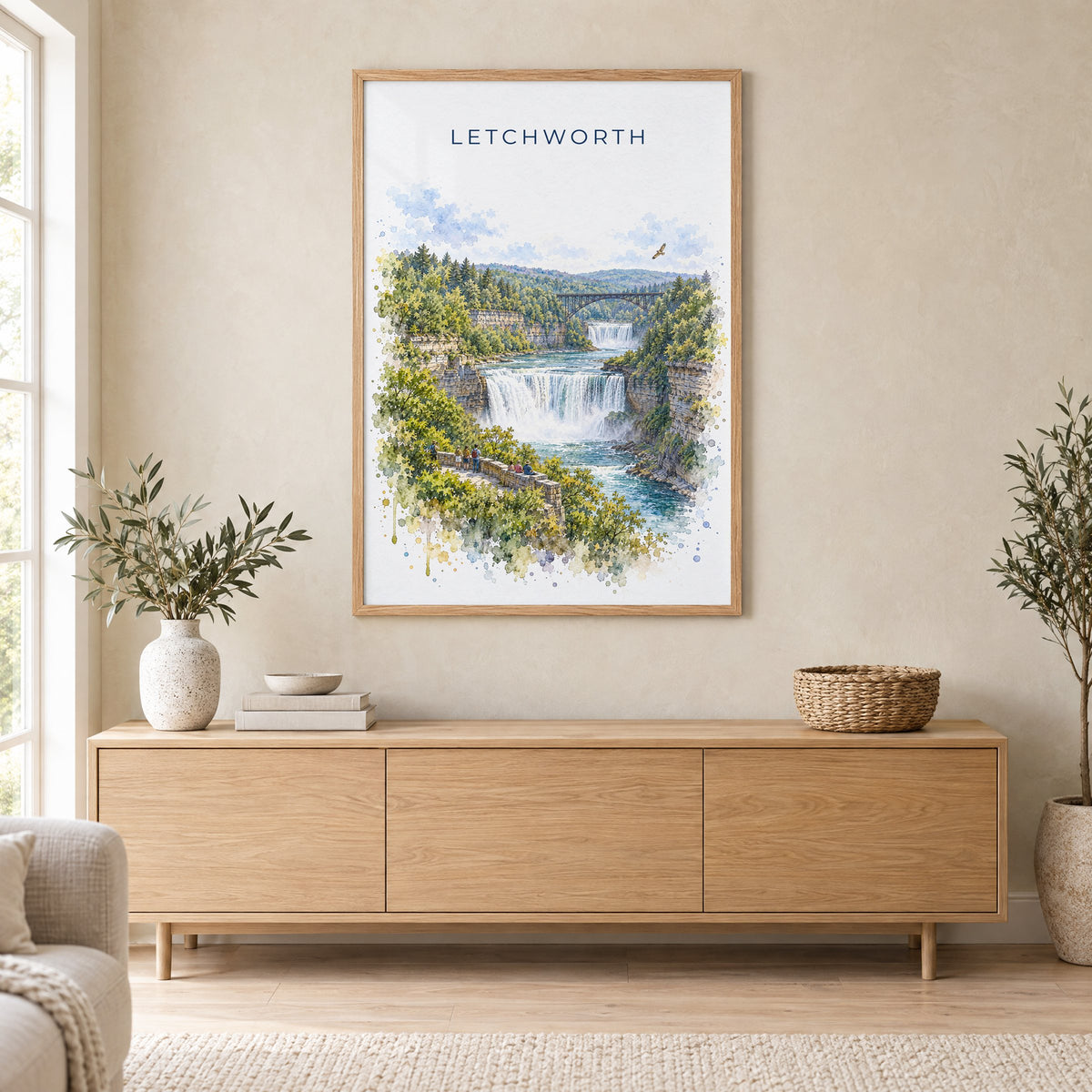Letchworth State Park watercolor print in an oak frame above a light wood sideboard in a Scandinavian living room