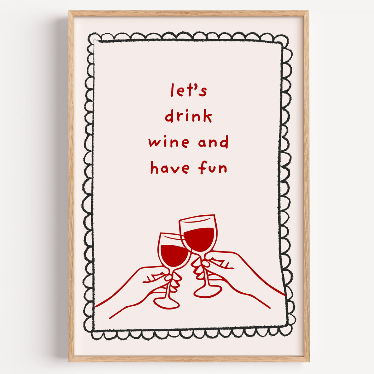 Lets Drink Wine and Have Fun print in a light oak frame on a plain white wall