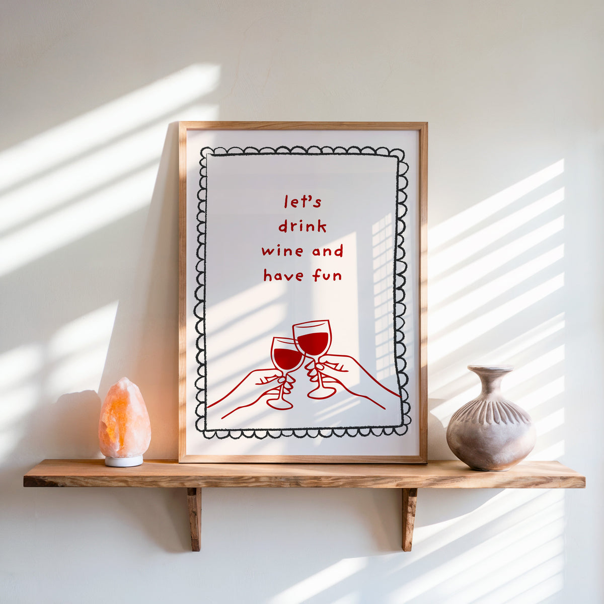 Lets Drink Wine and Have Fun print in an oak frame on a live-edge shelf beside a salt lamp