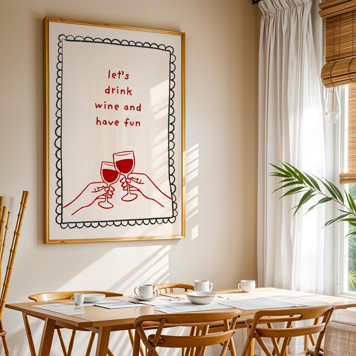 Lets Drink Wine and Have Fun print shown in a gold frame above a breakfast table by a curtained window
