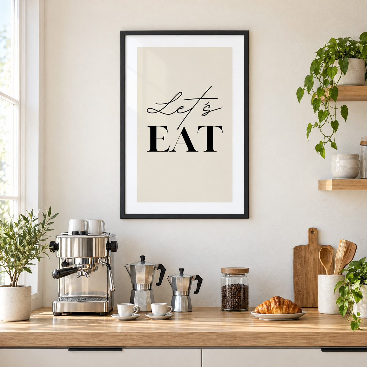 Let's EAT serif and script print in a black frame above a home espresso bar with moka pots and espresso cups