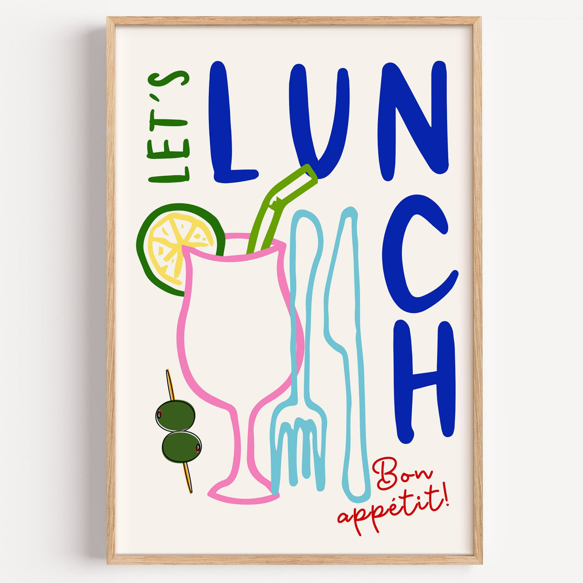 Let's Lunch cocktail and cutlery print in a light oak frame on a plain white wall