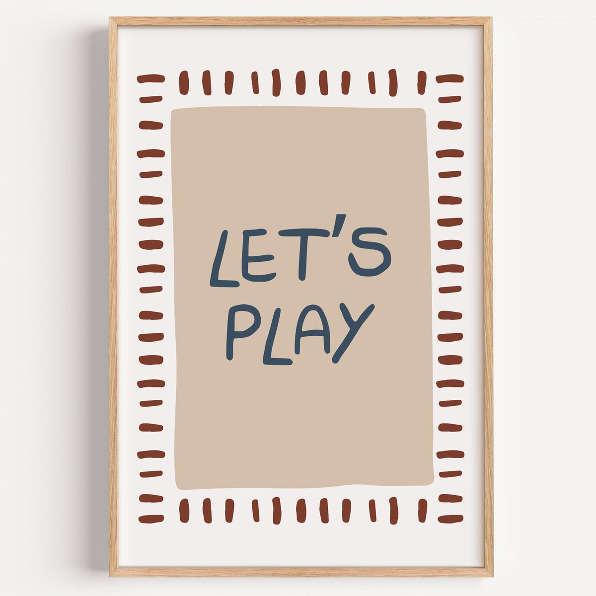 Lets play typography nursery print in a light oak frame on a plain white wall