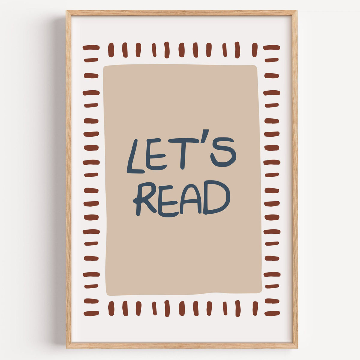 Lets read typography nursery print in a light oak frame on a plain white wall