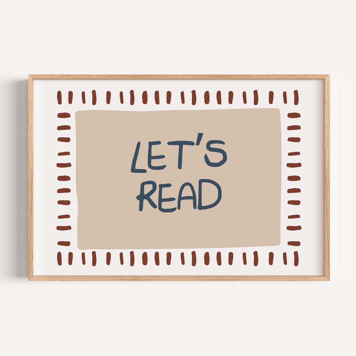 Landscape lets read typography nursery print in a light oak frame on a plain white wall