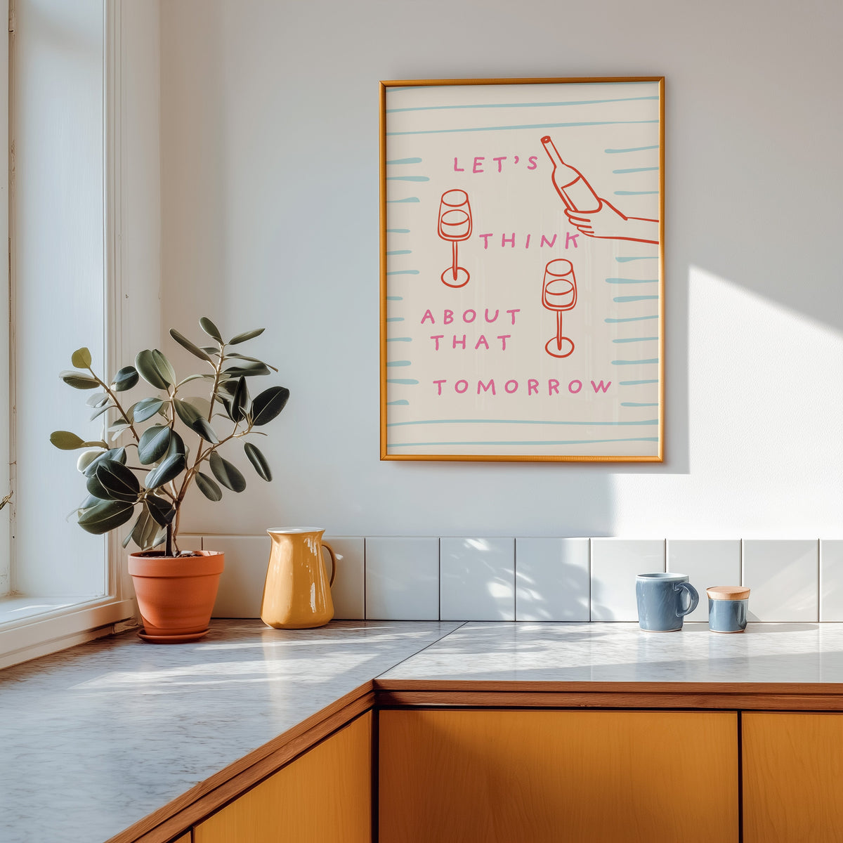 Wine pour line print shown in a gold frame above a marble counter with a yellow ceramic jug