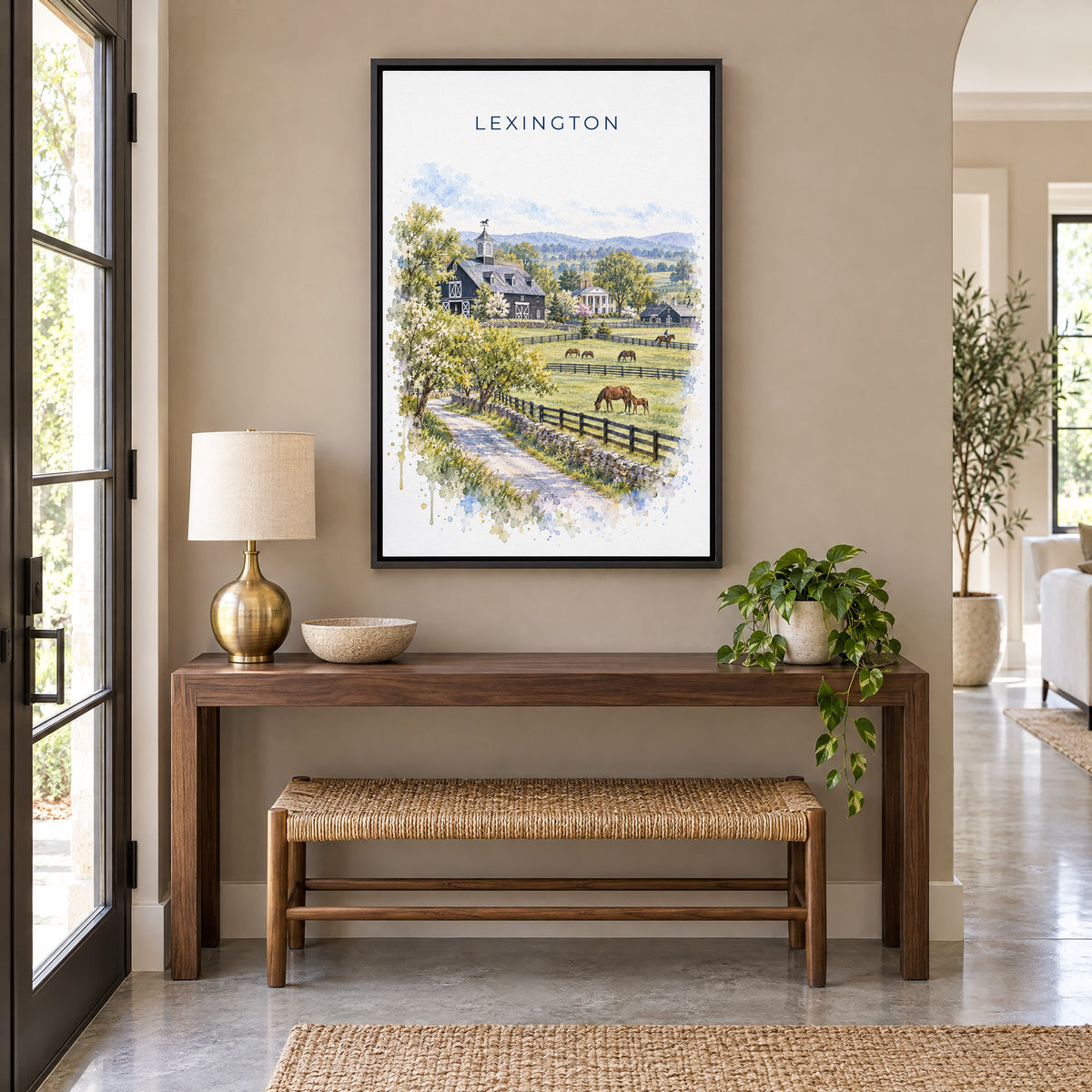 Lexington, Kentucky watercolor print as a black floater canvas above a walnut console and woven bench in an entryway
