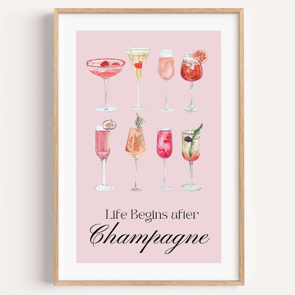 Life Begins after Champagne watercolor glasses print in a light oak frame on a plain white wall