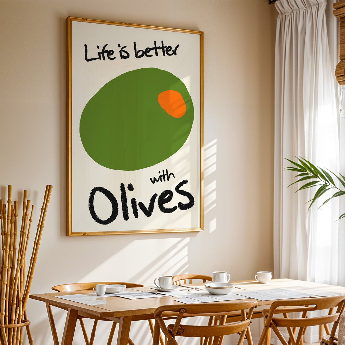 Life is better with olives print in a gold frame above a sunlit breakfast table