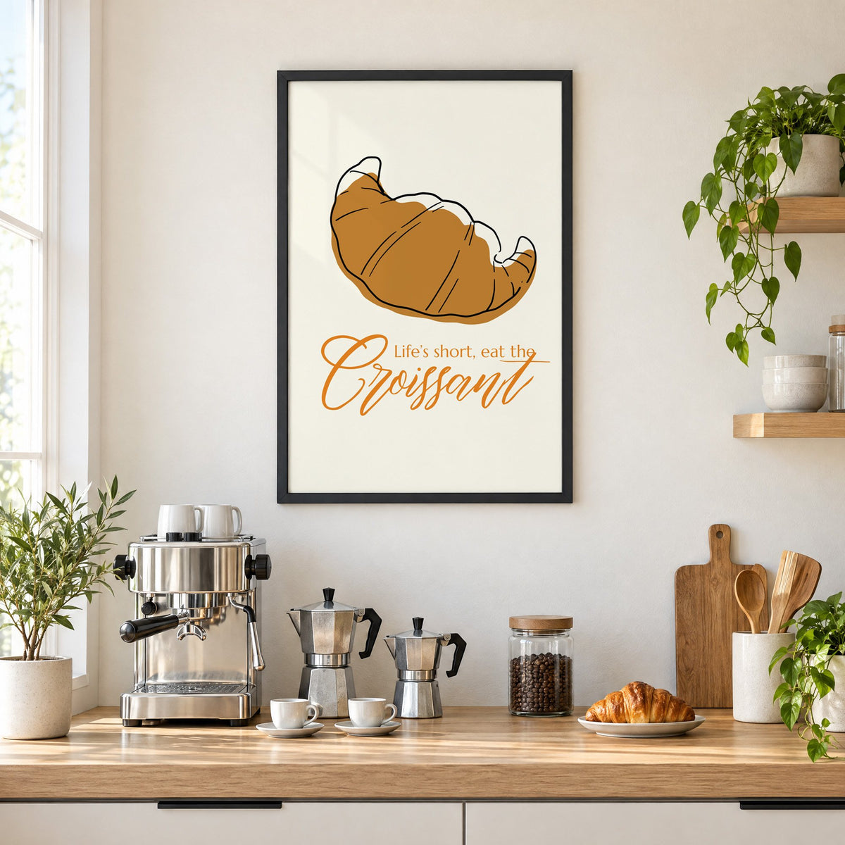 Life's short, eat the Croissant print in a black frame above a home espresso bar with moka pots and espresso cups