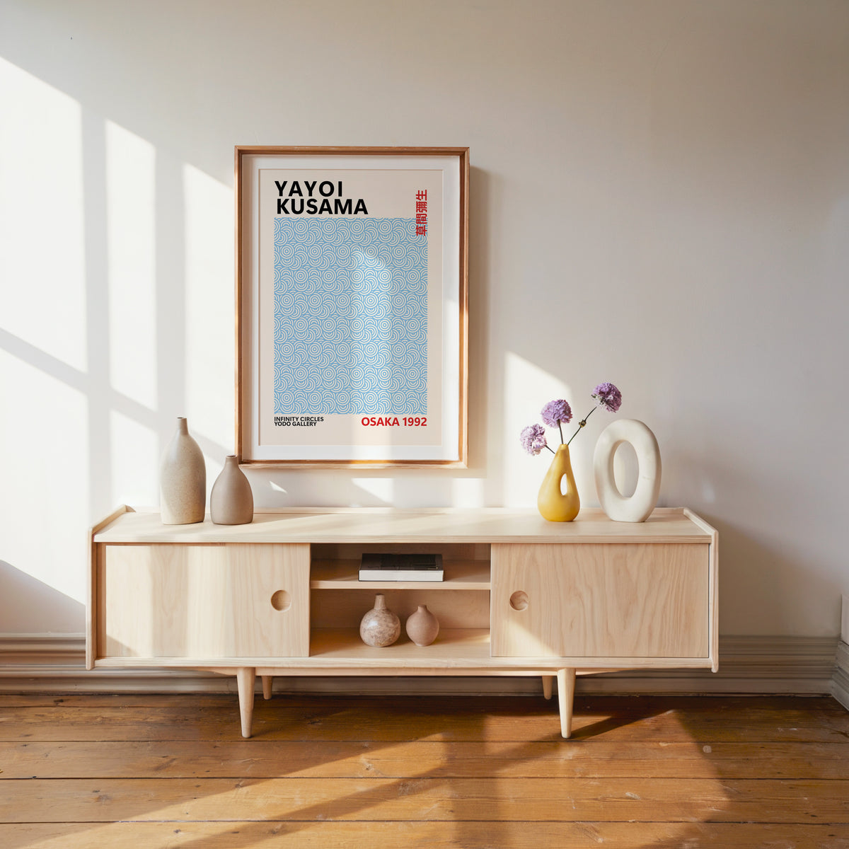 Yayoi Kusama inspired light blue circle pattern print above a pale wood console
