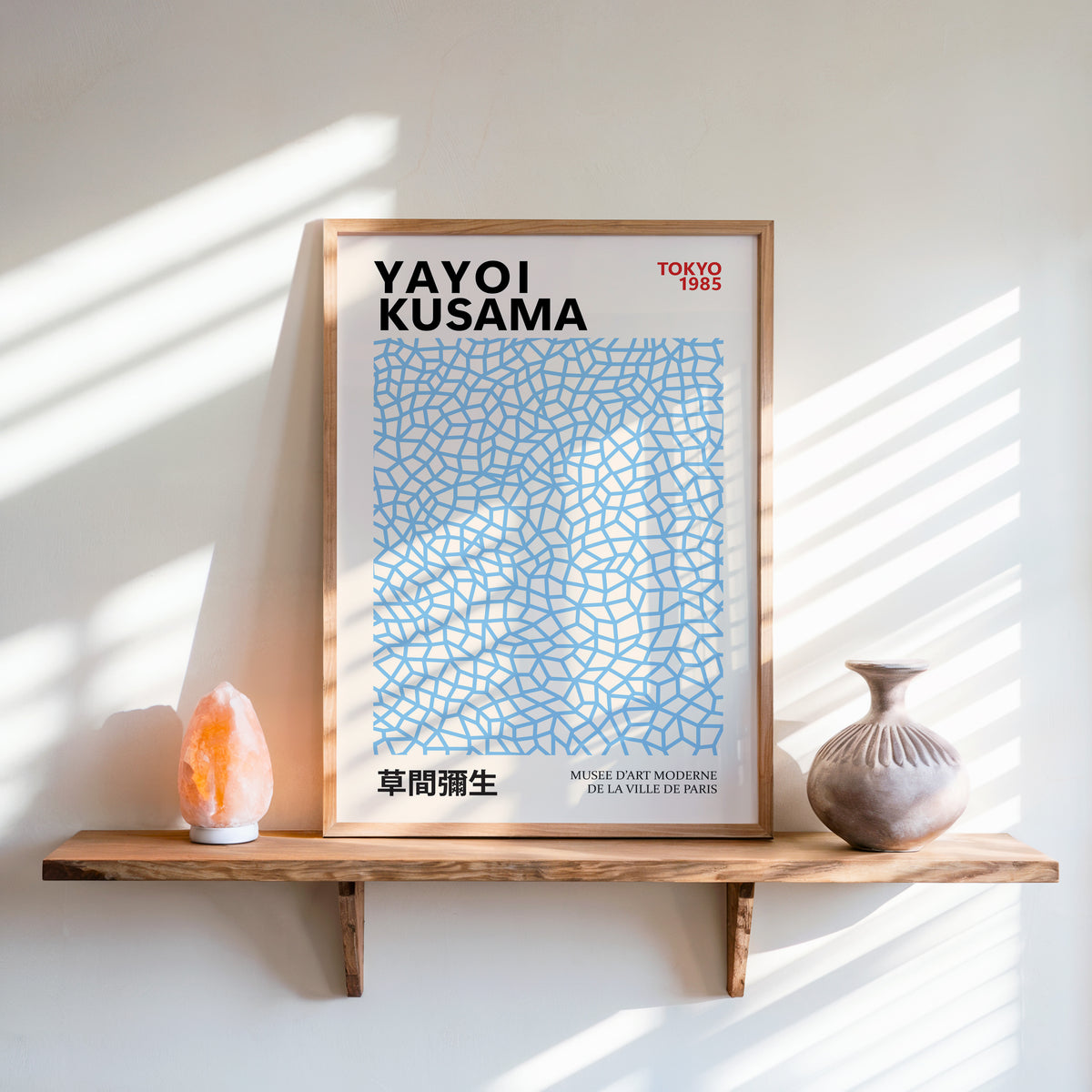 Yayoi Kusama inspired light blue net pattern print above a shelf with a salt lamp