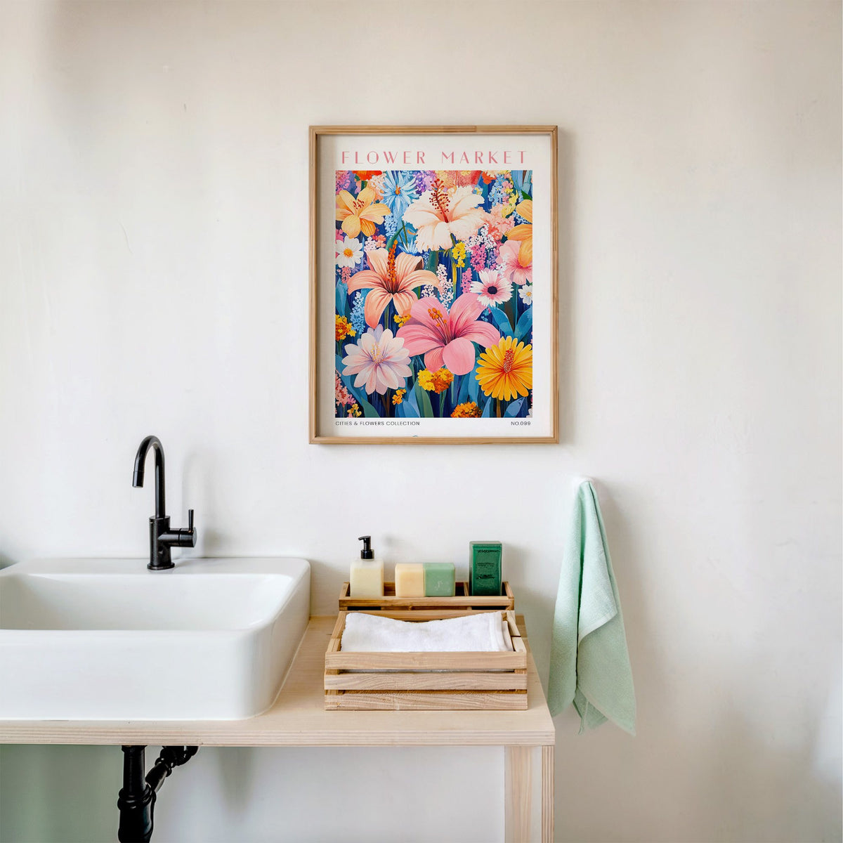 Lima flower market print in an oak frame above a white bathroom sink with folded towels