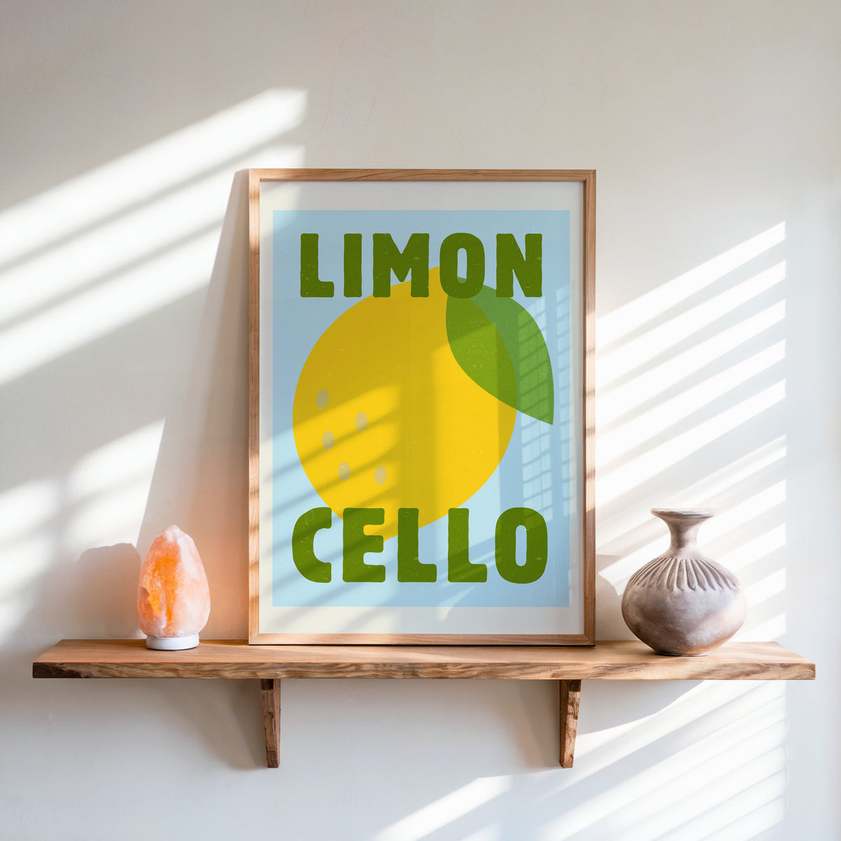 Limoncello print in an oak frame on a live-edge shelf beside a salt lamp