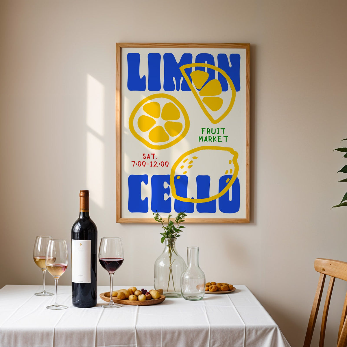 Limoncello lemon print in an oak frame above a table laid with red wine and glasses