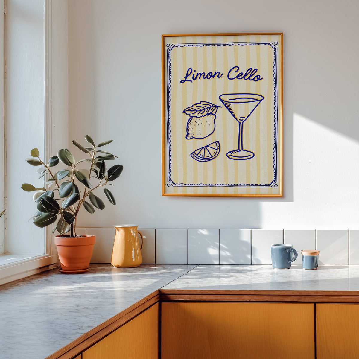 Limoncello martini print shown in a gold frame above a marble counter with a yellow ceramic jug