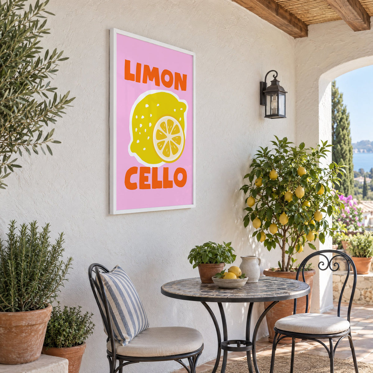 Limon Cello lemon and slice print in a white frame on a sunny patio wall beside a potted lemon tree