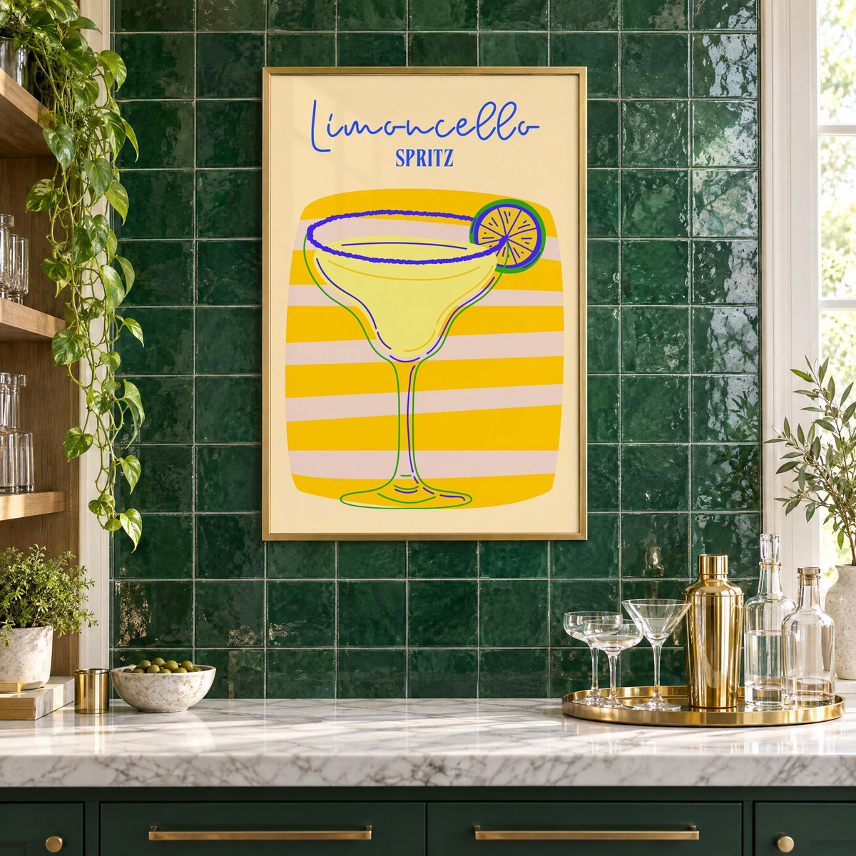 Limoncello Spritz yellow stripe print in a brass frame on emerald green tiles above a home bar with coupe glasses