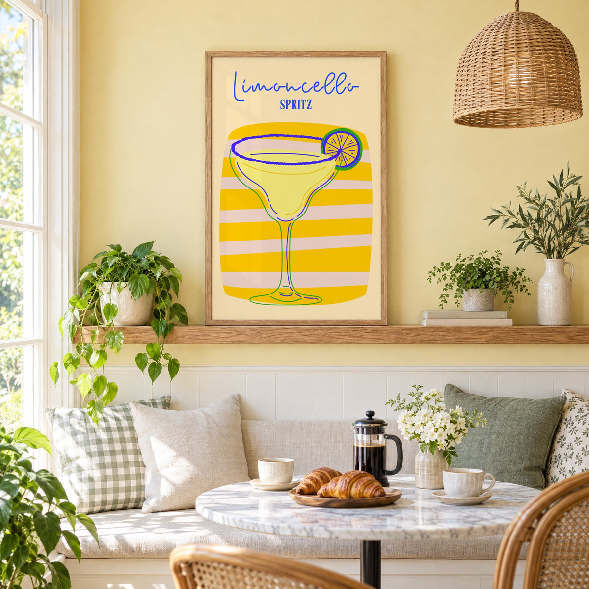 Limoncello Spritz yellow stripe print in an oak frame on a picture ledge above a sunny breakfast nook