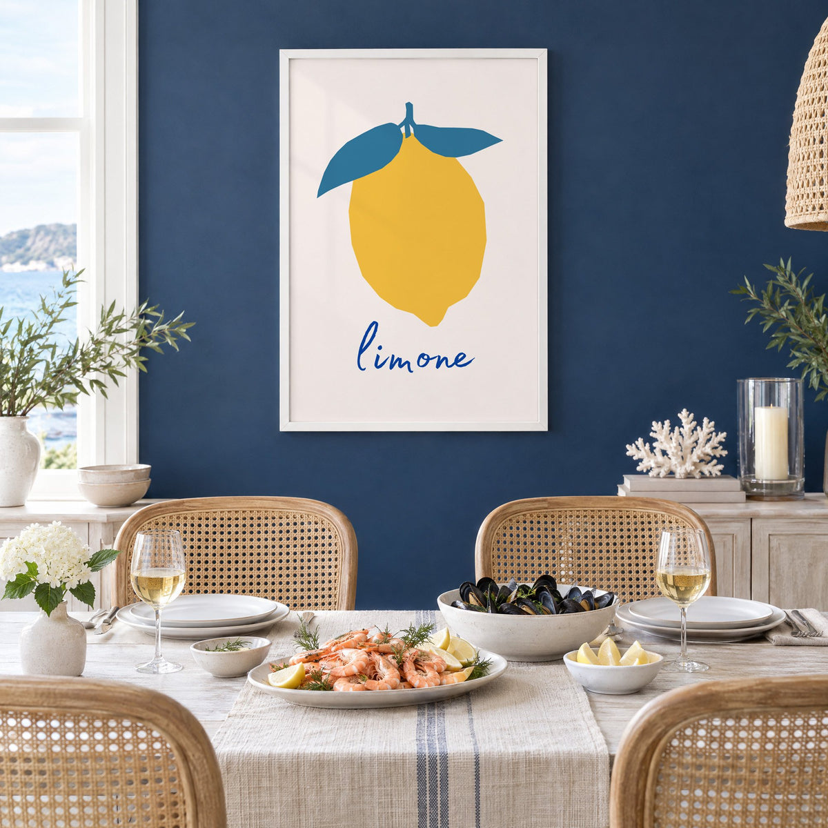 limone yellow cut-paper lemon print in a white frame on a navy wall above a dining table set with shrimp and mussels