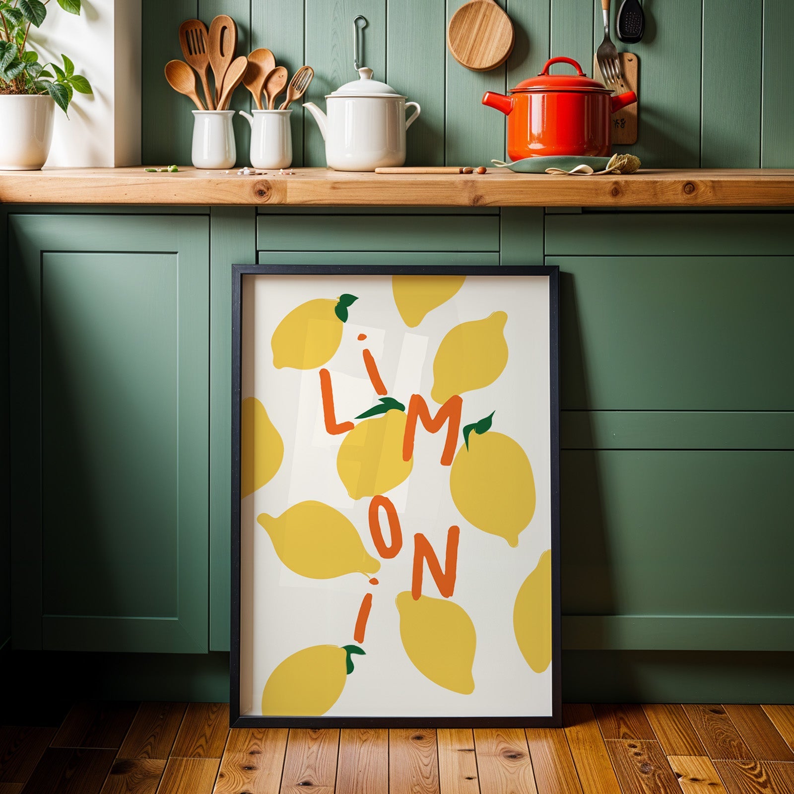 Limoni lemon pattern print in a black frame against sage green kitchen cabinets