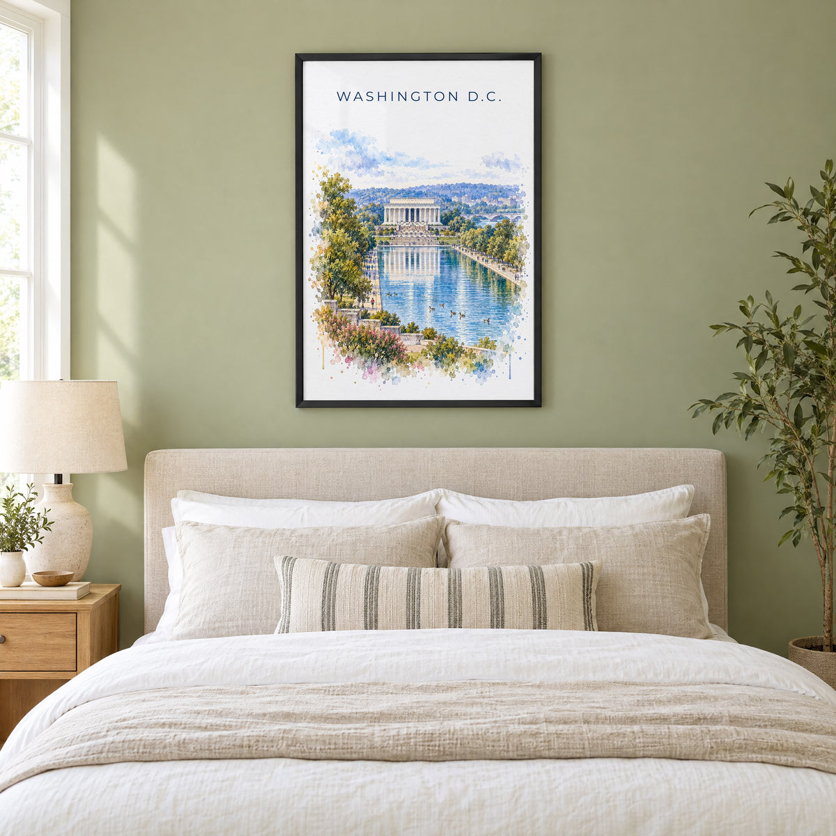 Lincoln Memorial watercolor print in a black frame above an upholstered headboard in a sage green bedroom