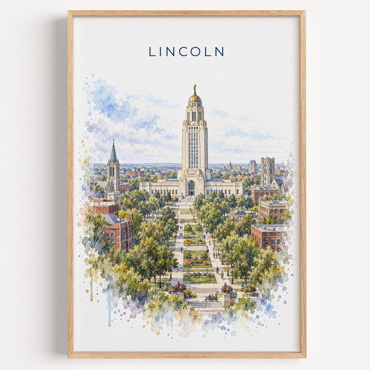 Lincoln, Nebraska watercolor print in a light oak frame on a plain white wall