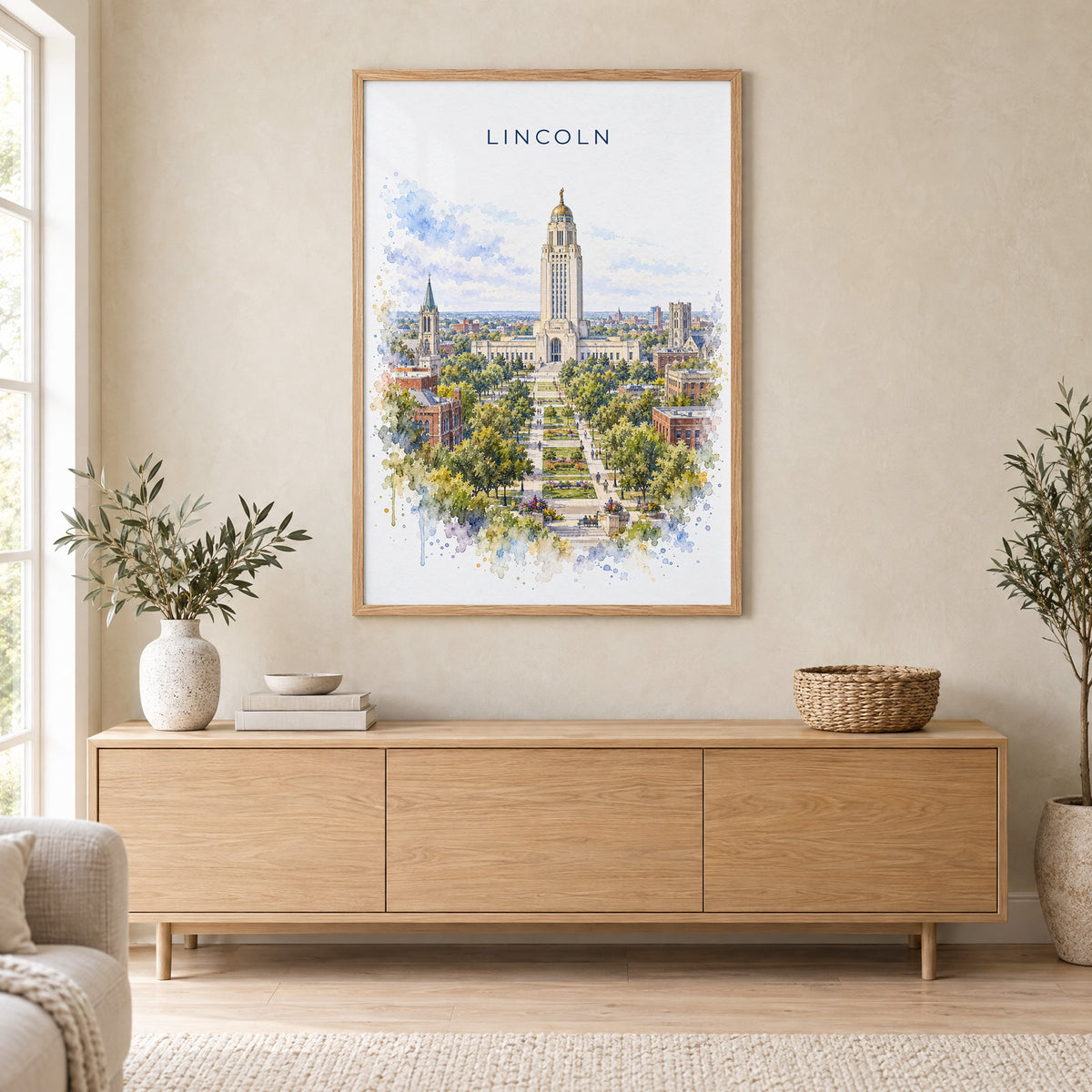 Lincoln, Nebraska watercolor print in an oak frame above a light wood sideboard in a Scandinavian living room
