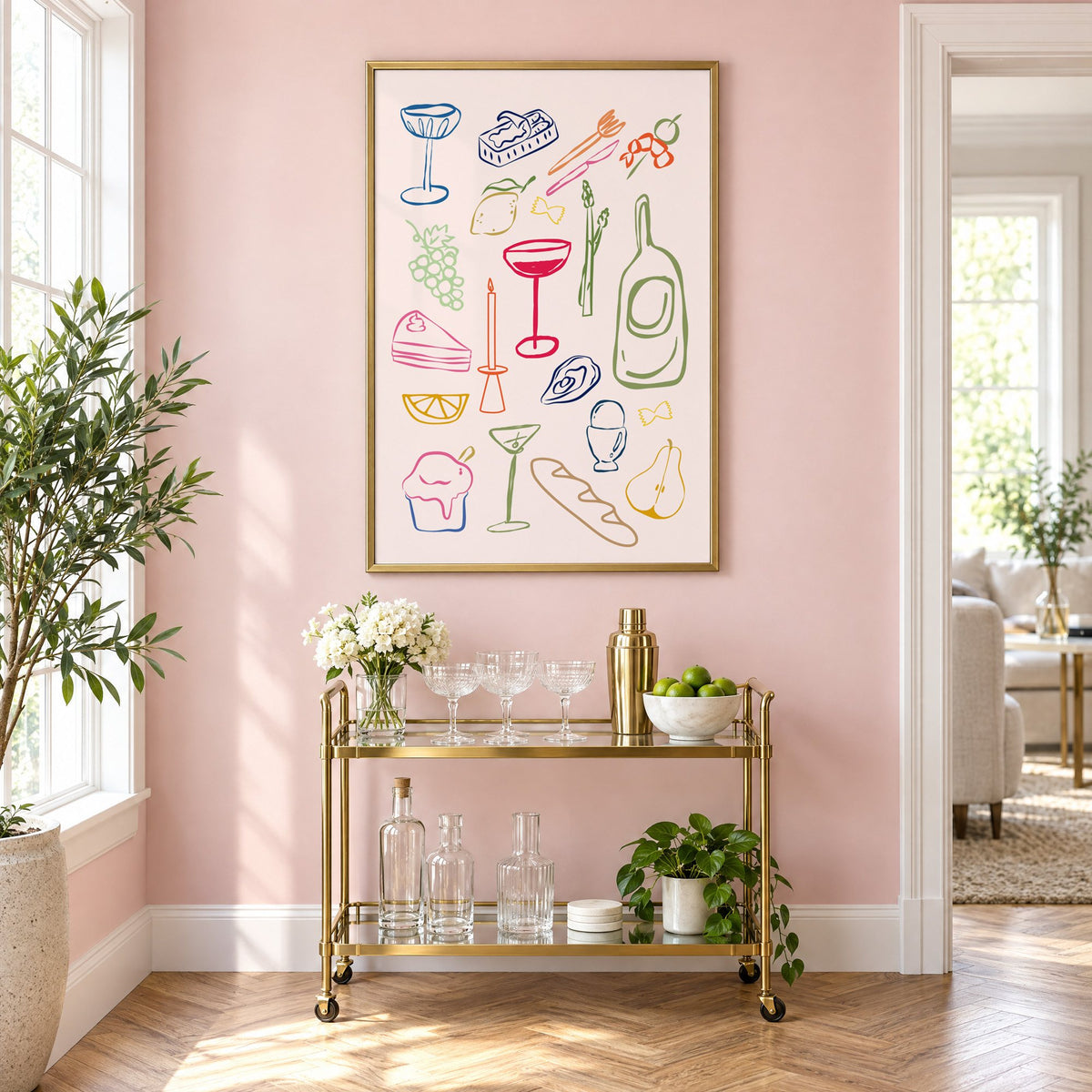 Line art candle coupe dinner party print in a brass frame above a gold bar cart on a blush pink wall