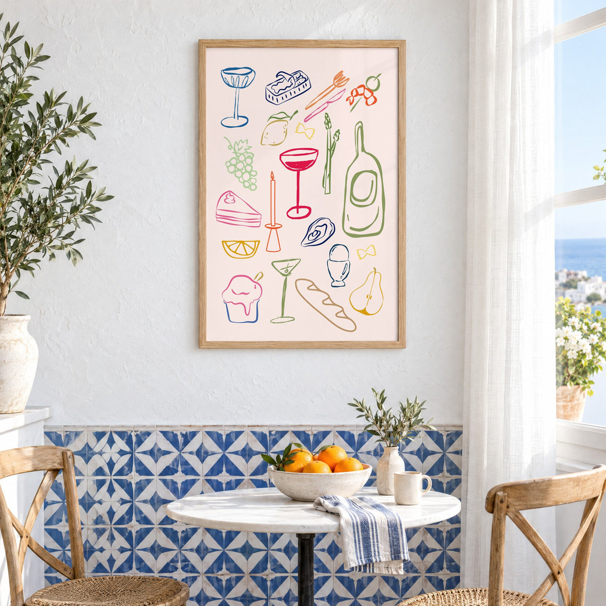 Line art candle coupe dinner party print in an oak frame above a bistro table and blue patterned tiles