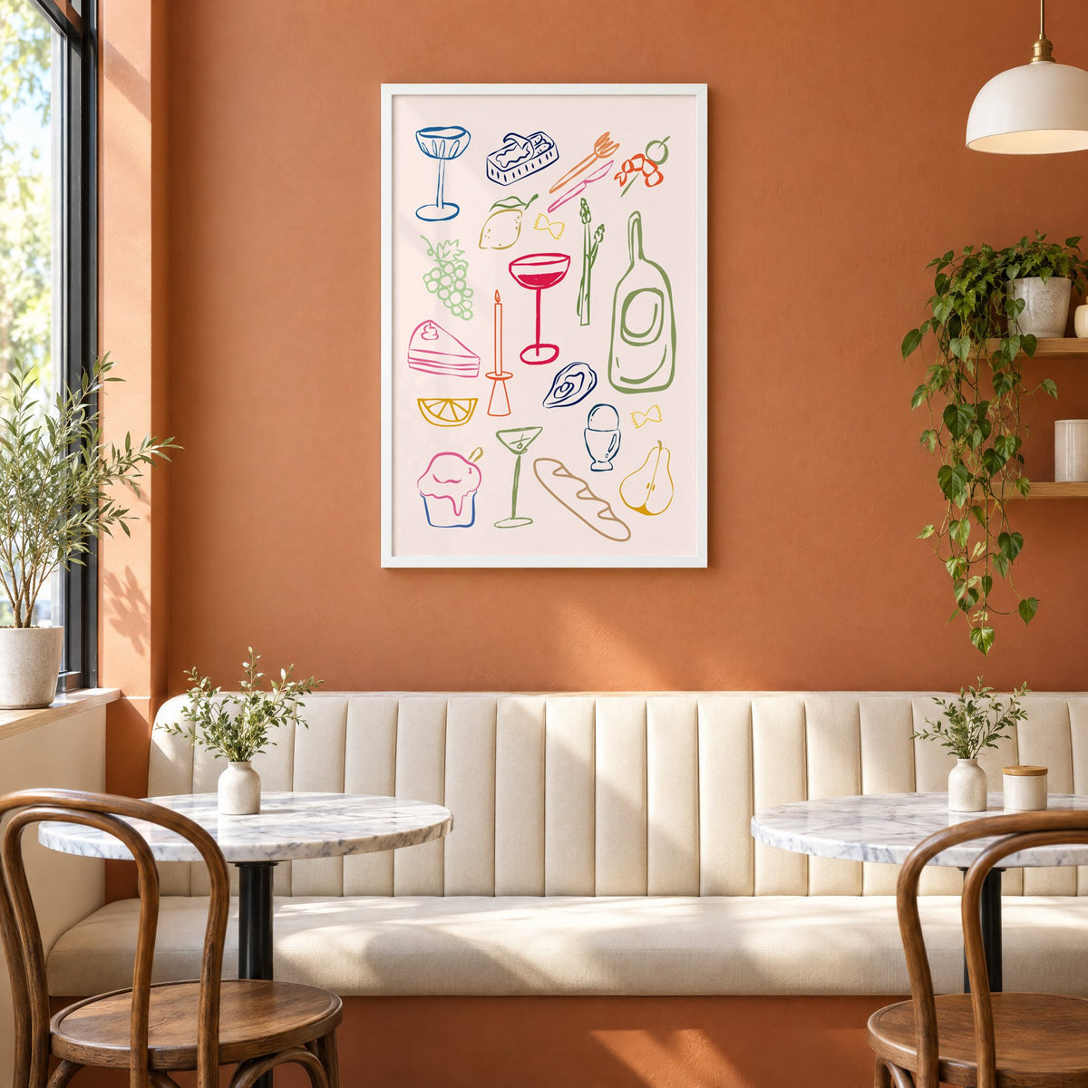Line art candle coupe dinner party print in a white frame above a cream banquette on a terracotta cafe wall
