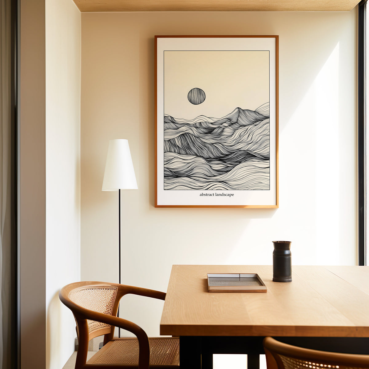 Line art mountain and sun abstract landscape print in a slim oak frame above a dining table with a cane-back chair