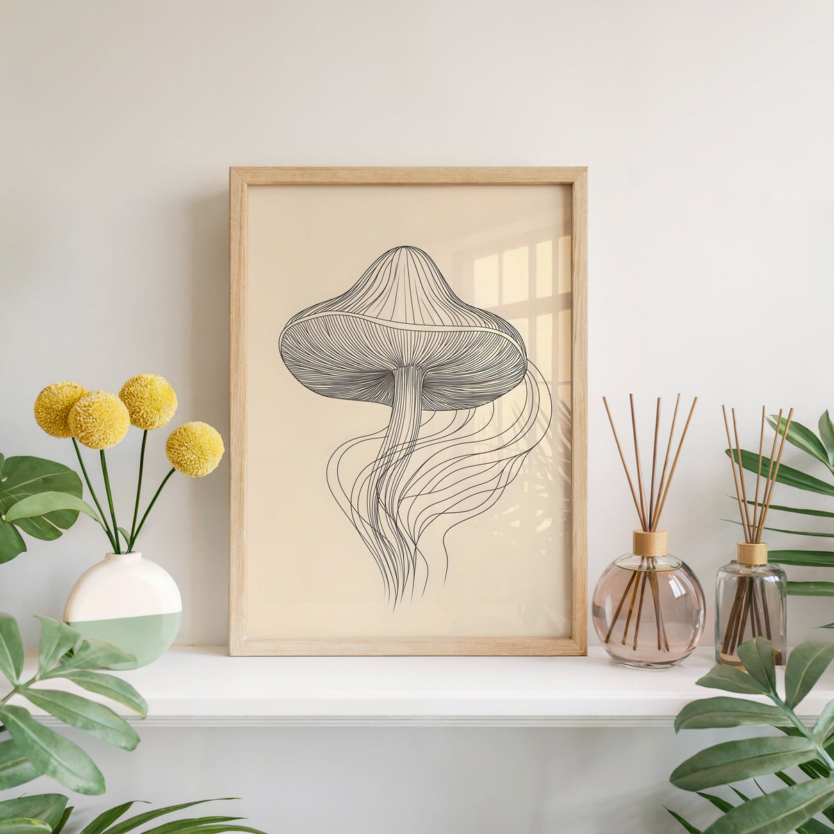 Line art mushroom with flowing lines print in a light oak frame leaning on a white mantel with yellow flowers
